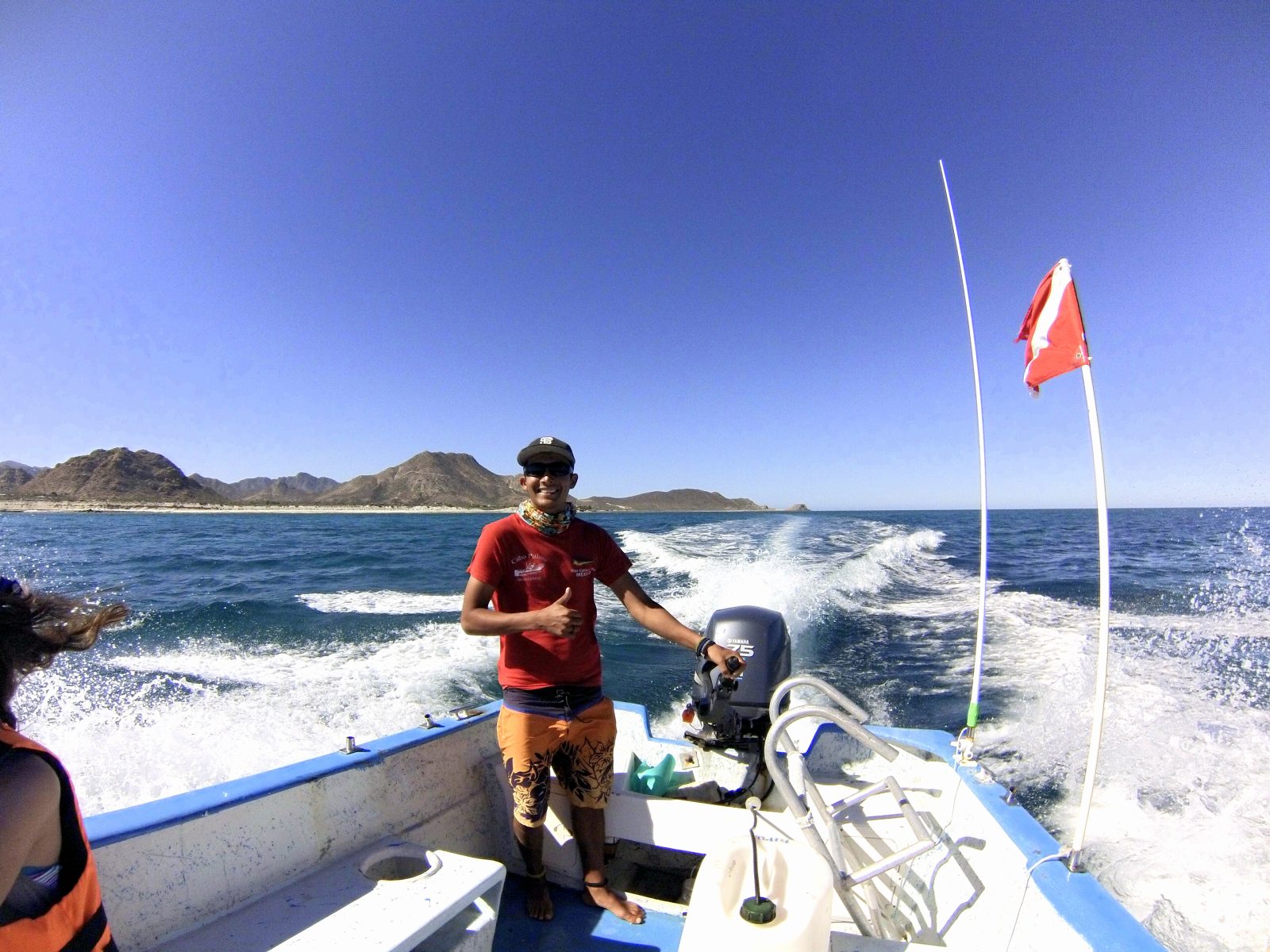 Dive master on a Cabo Pulmo Dive Center panga with the diver-down flag raised Dive master on a Cabo Pulmo Dive Center panga with the diver-down flag raised