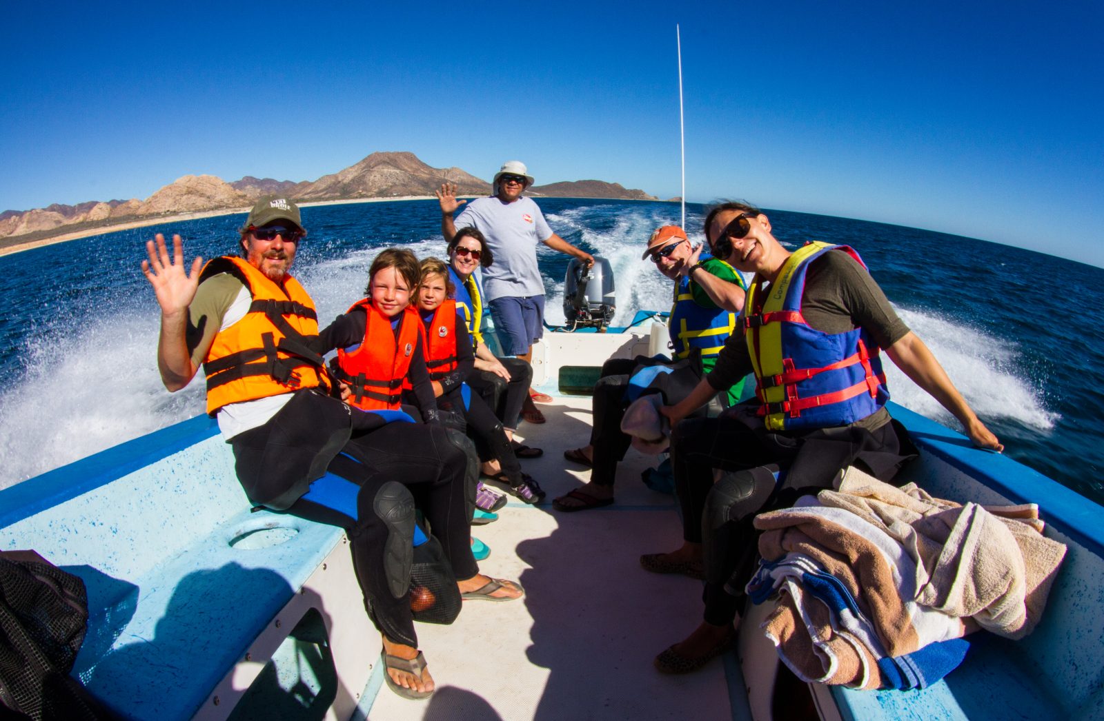 Family group in life vests on the Cabo Pulmo Dive Center boat heading to the snorkel sites Family group in life vests on the Cabo Pulmo Dive Center boat heading to the snorkel sites